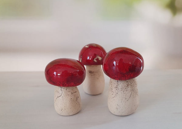 Ceramic red miniature mushrooms in variety of sizes and shapes