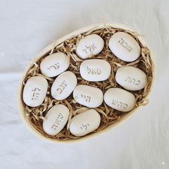 Set of three Kabbalah stones with mystical Hebrew symbols arranged in a circle on a wooden table